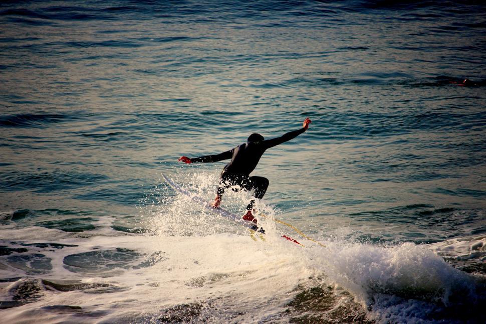 Free Image of Man Riding Wave on Surfboard 