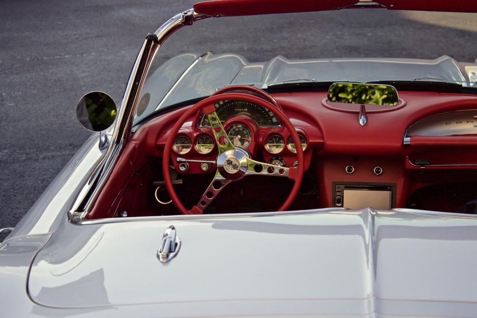 Free Image of Red and White Car With Steering Wheel 