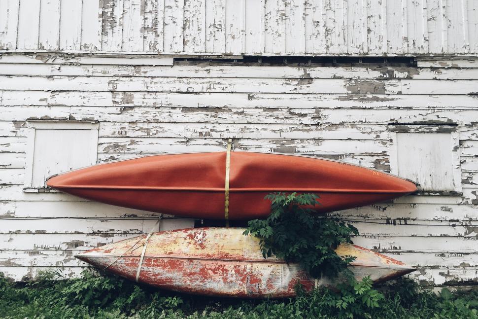 Free Image of Red Surfboard Resting on Top of Surfboard Stack 