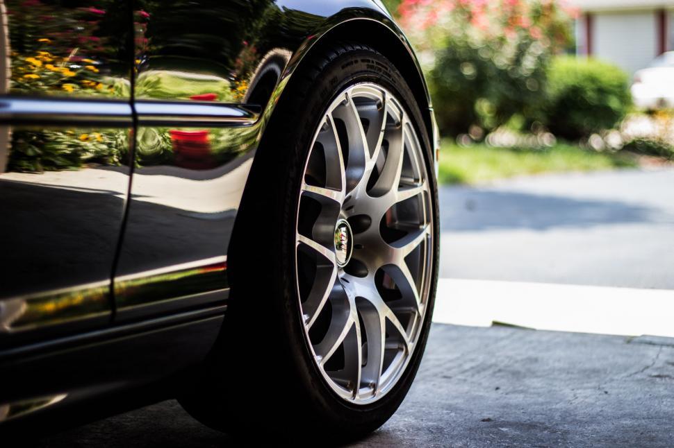 Free Image of Close Up of a Car Tire on a Driveway 