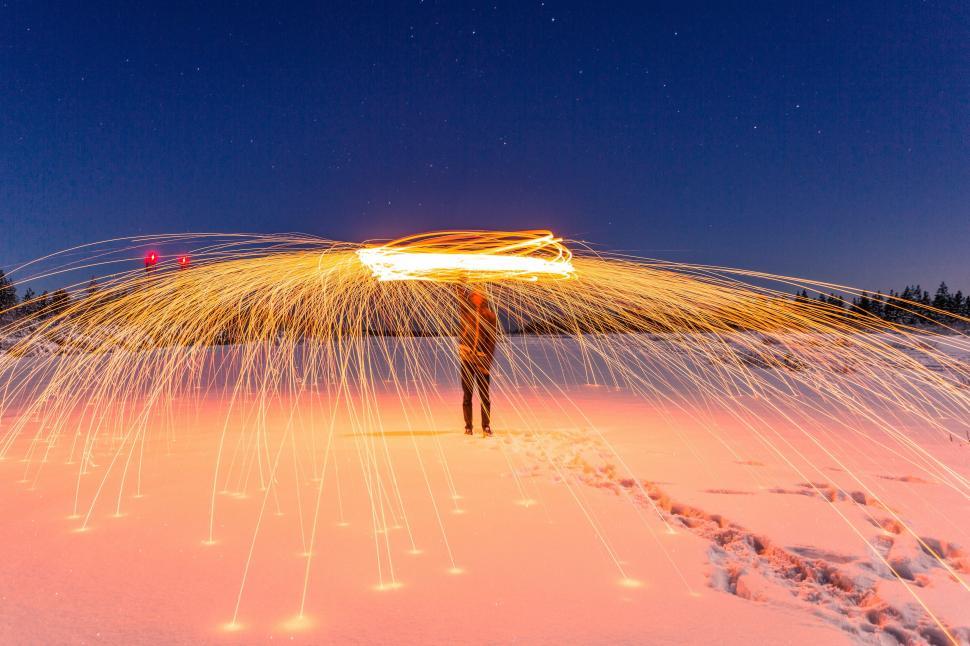 Free Image of Person Standing in Snow Holding Light Saber 