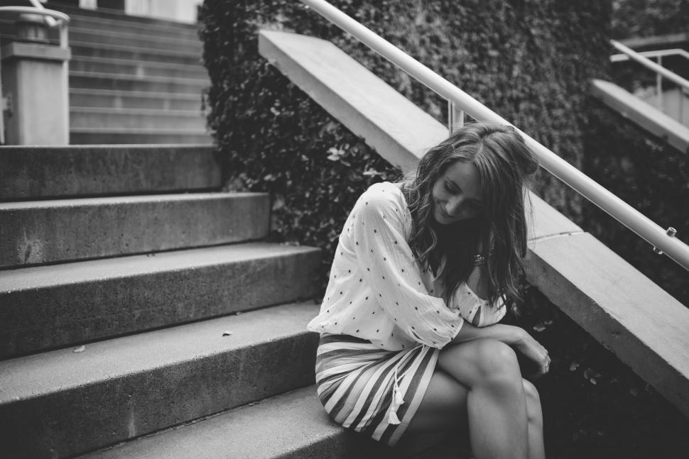Free Image of Woman Sitting on a Set of Stairs 