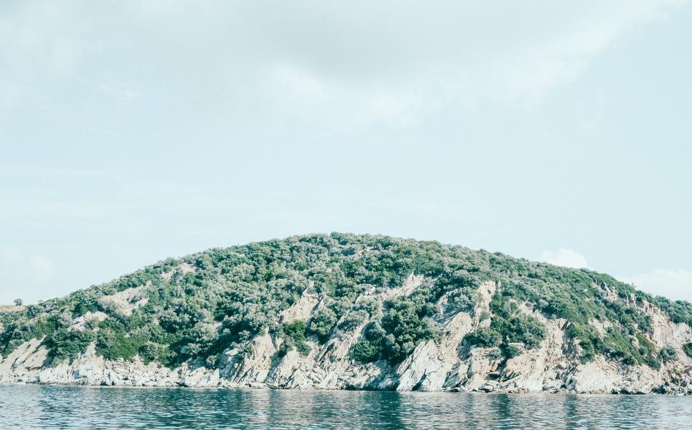 Free Image of Small Island Amidst Body of Water 