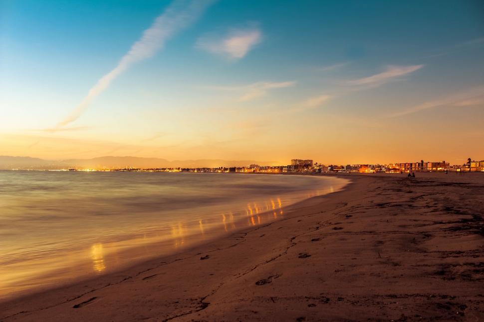 Free Image of Sunset View of Beach With Buildings 