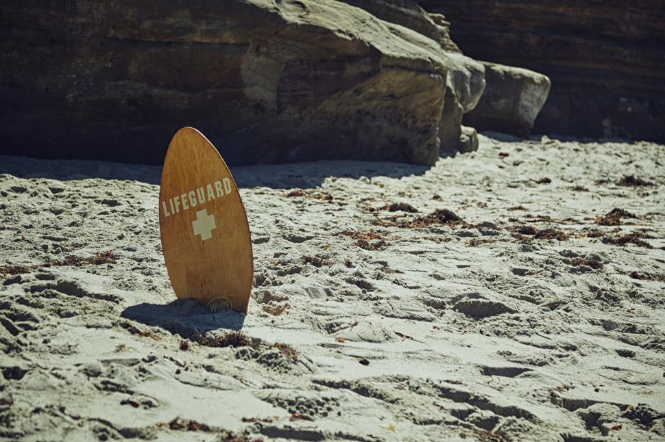 Free Image of Surfboard Resting on Beach Sand 