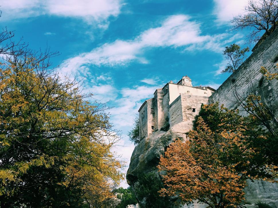 Free Image of Castle Perched on Rock Amidst Trees 