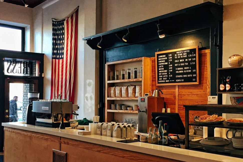 Free Image of Flag Hanging Above Counter in Coffee Shop 