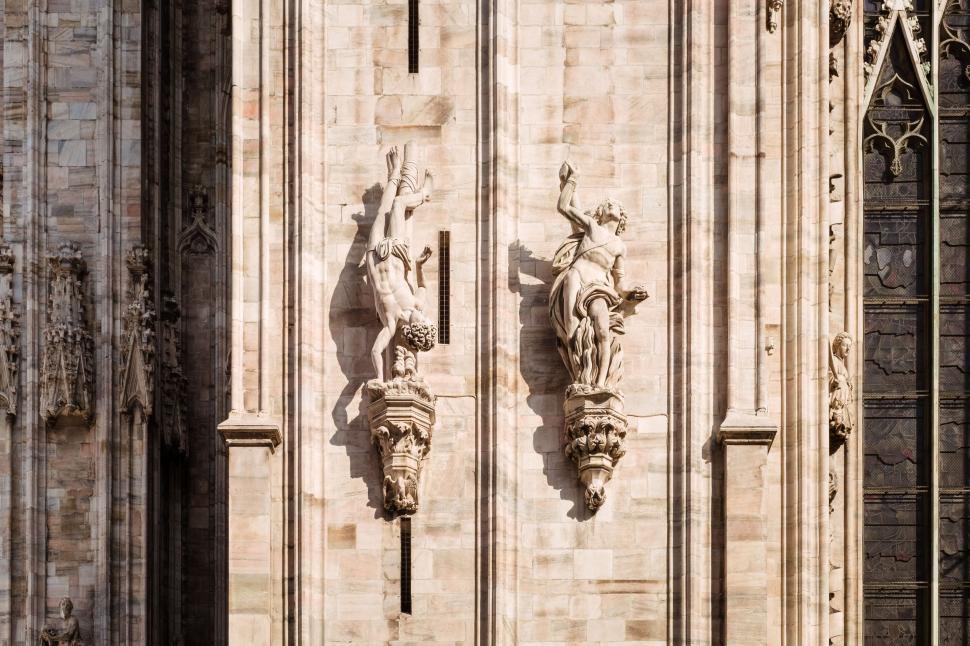 Free Image of Two Statues Adorning a Building Facade 