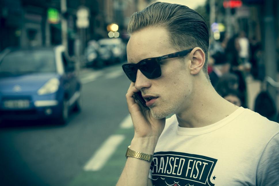 Free Image of Man With Sunglasses Talking on Cell Phone 