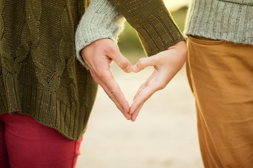 Free Image of Two People Making a Heart Gesture 