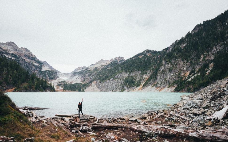 Free Image of Person Standing in Front of a Mountain Lake 
