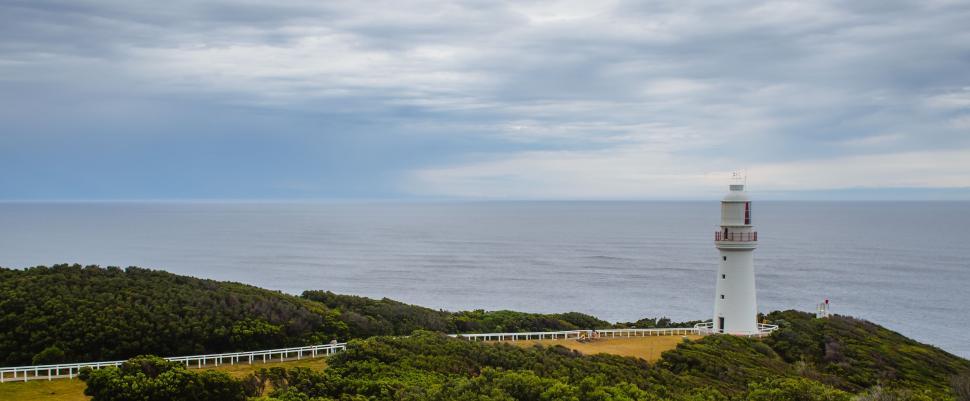 Free Image of Lighthouse on Hill Overlooking Ocean 