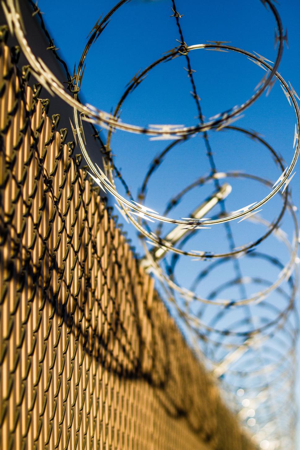 Free Image of Close Up of Fence With Barbed Wire 