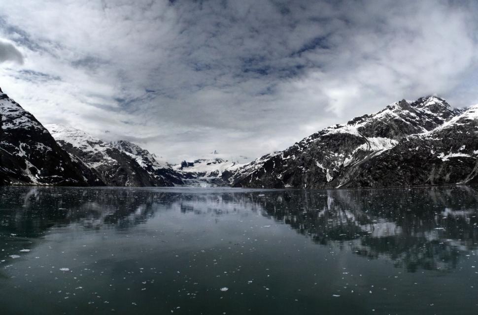 Free Image of Snow Covered Mountains Surrounding Large Body of Water 