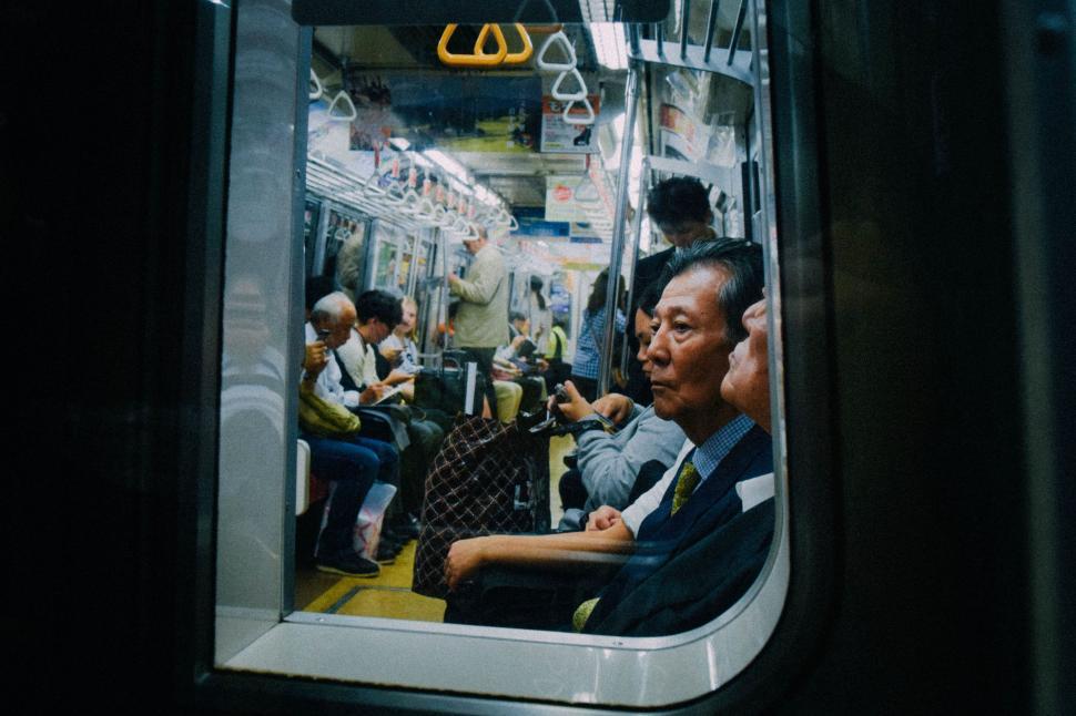 Free Image of Group of People Sitting on a Train 