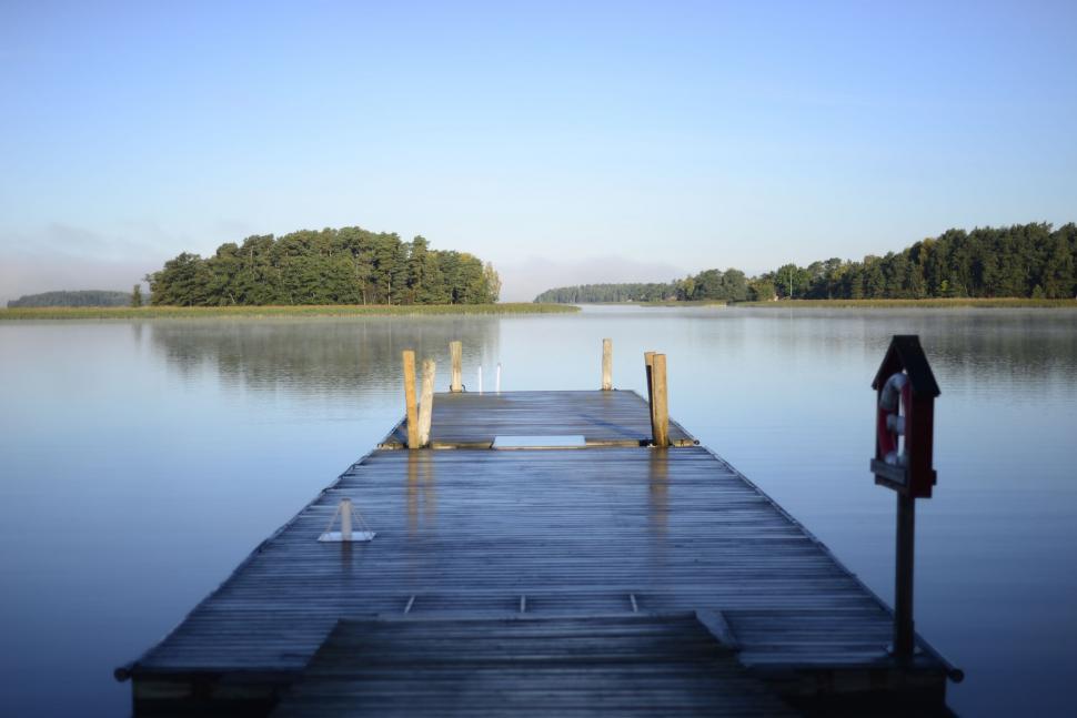 Free Image of Dock Overlooking Lake Beside Forest 
