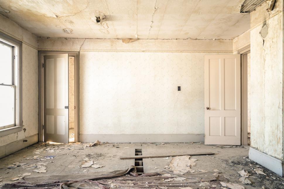 Free Image of An Empty Room With a Door and a Window 