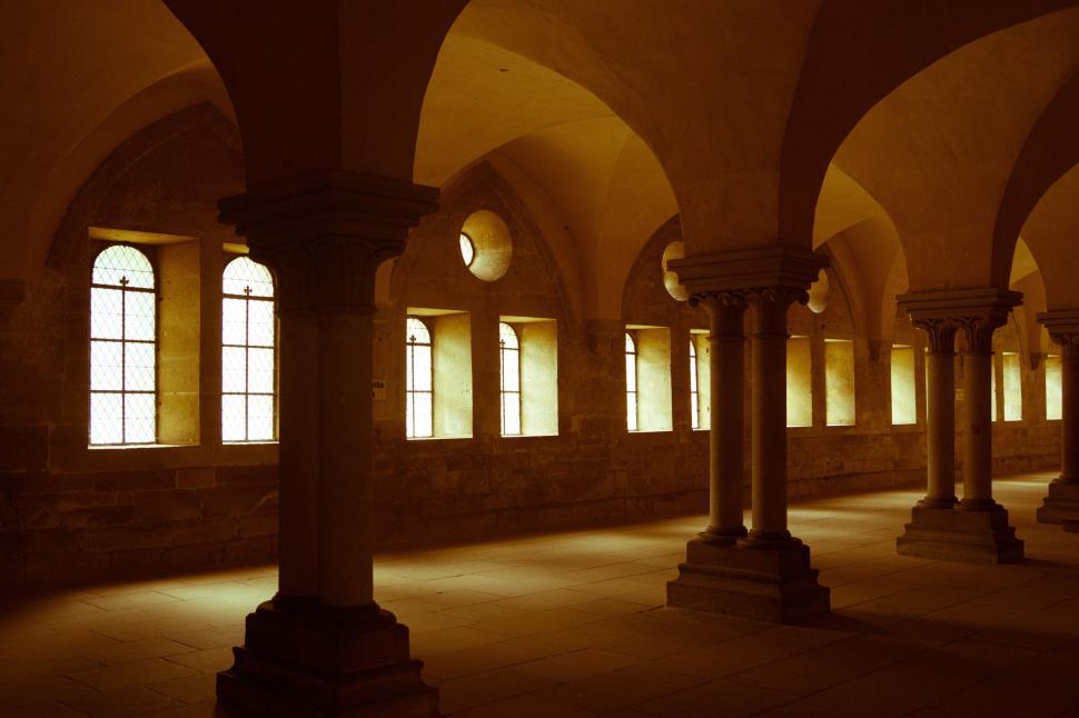 Free Image of Dimly Lit Room With Columns and Windows 