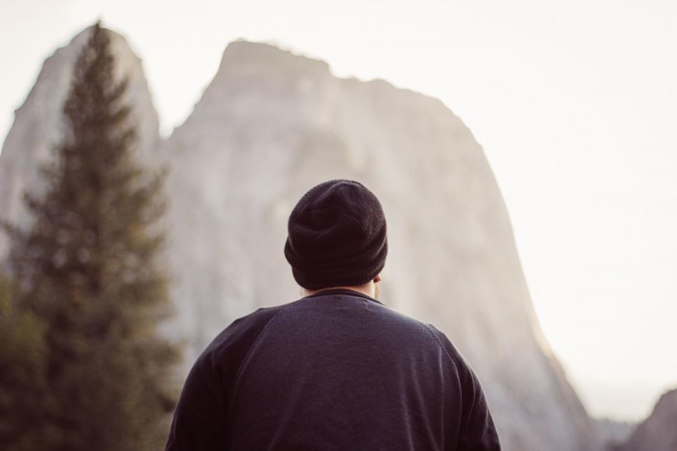 Free Image of Man Standing in Front of Tall Mountain 