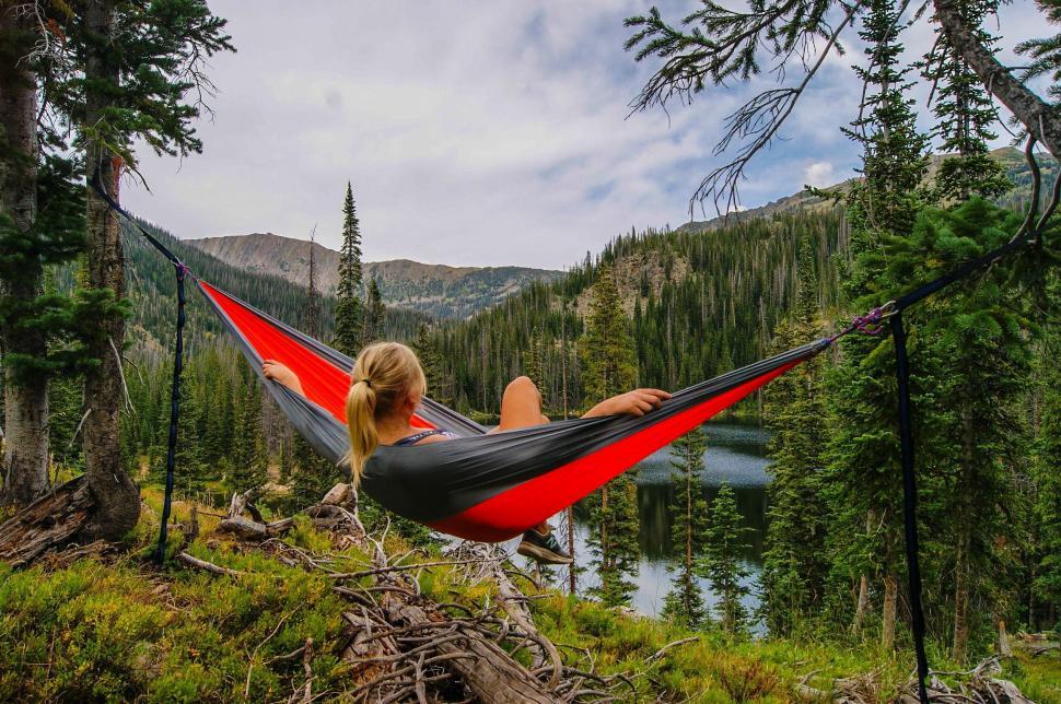 Free Image of Woman Relaxing in Hammock in Forest 
