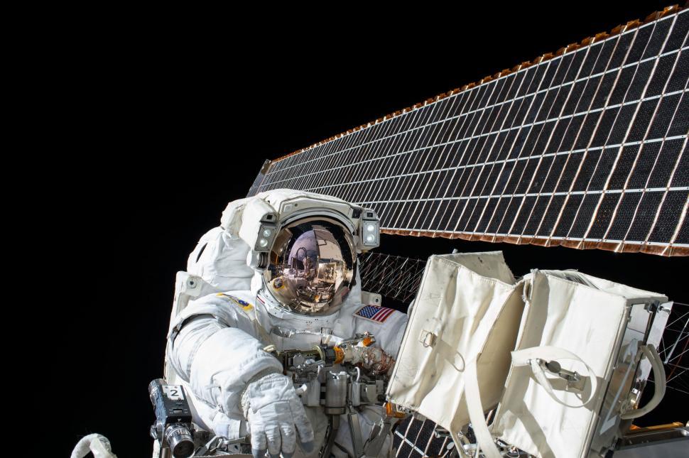 Free Image of Astronaut Sitting in Front of Satellite 