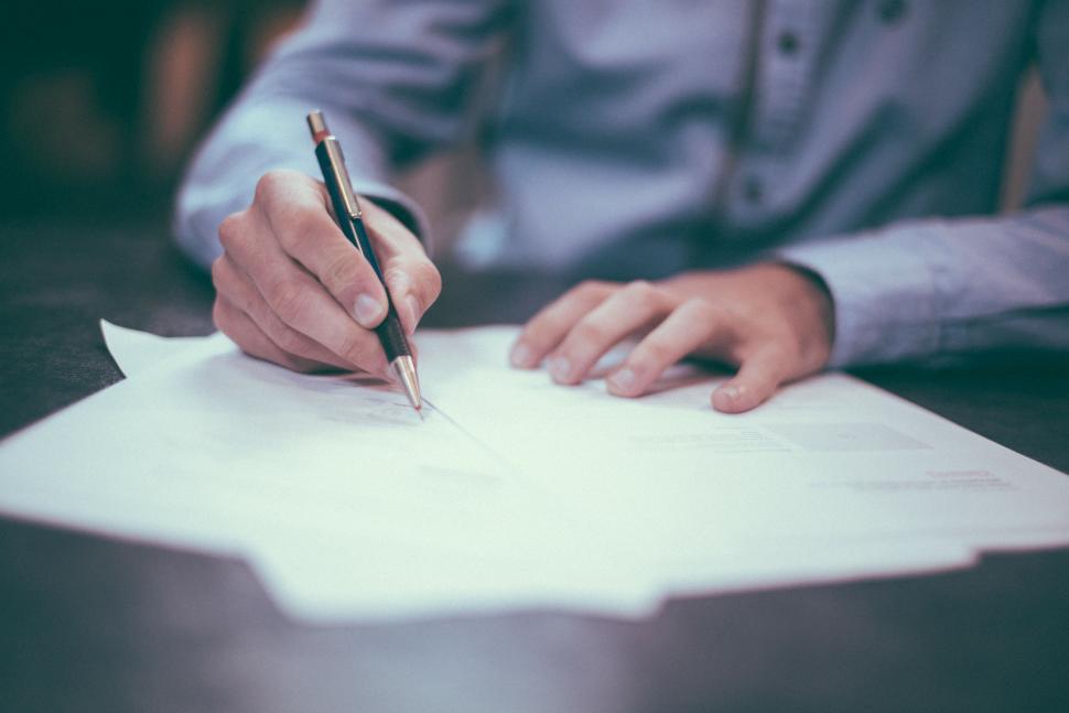 Free Image of Person Writing on a Piece of Paper With a Pen 