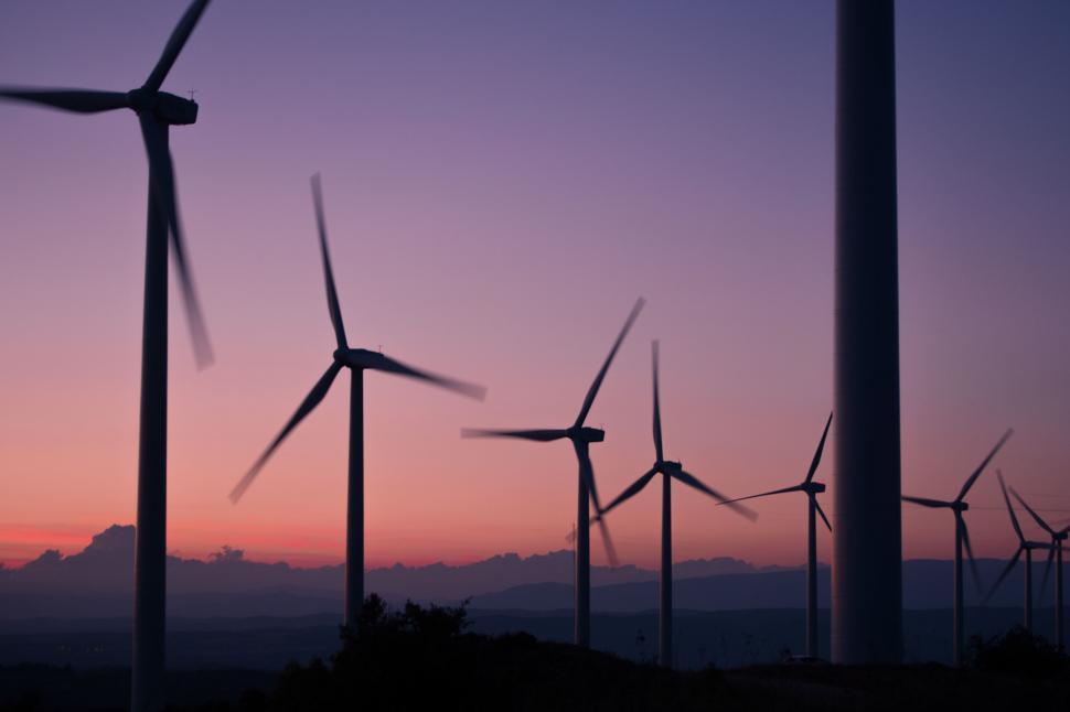 Free Image of Windmills Silhouetted Against Sunset 