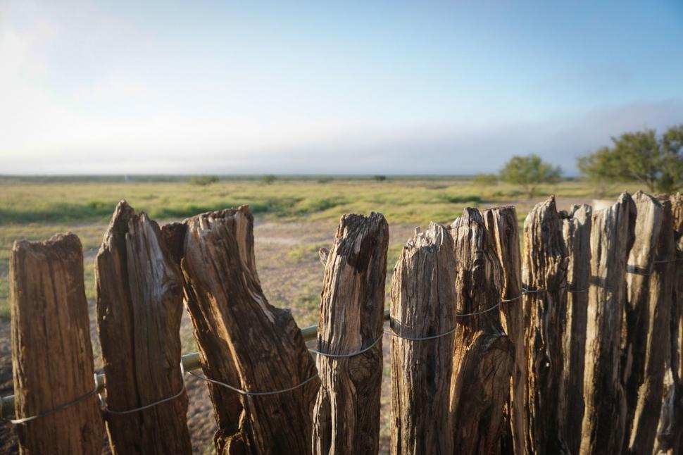 Free Image of Wooden Fence in Field With Sky Background 