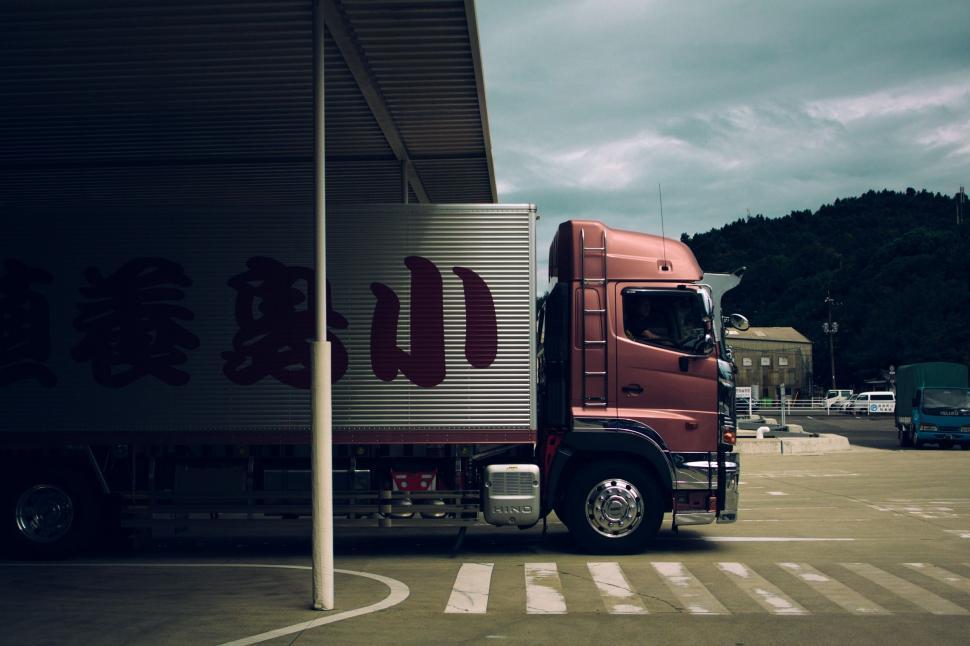 Free Image of Red Semi Truck Parked in Parking Lot 