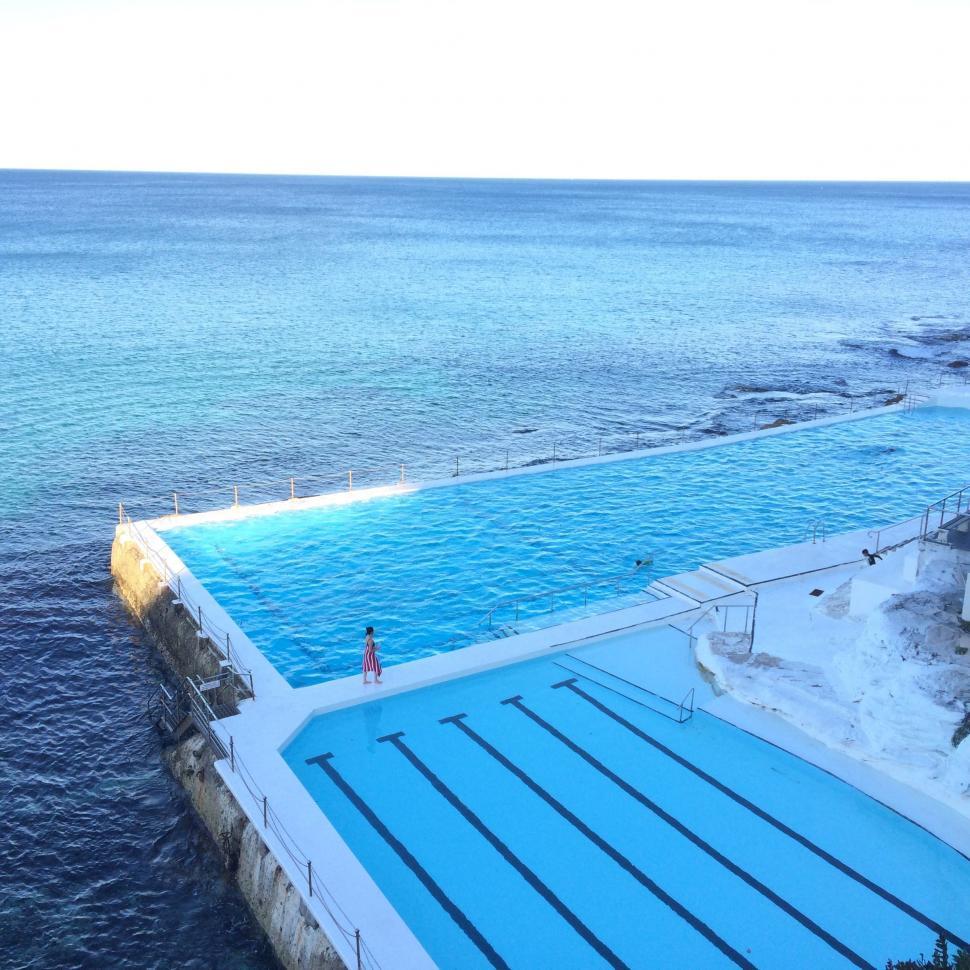 Free Image of Large Swimming Pool Next to the Ocean 