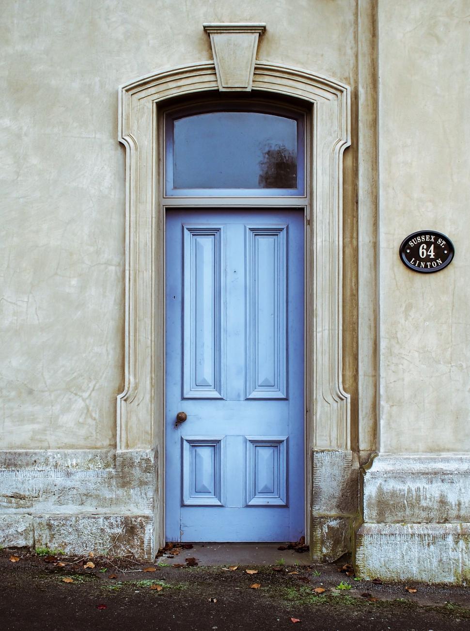 Free Image of Blue Door in Front of Tan Building 