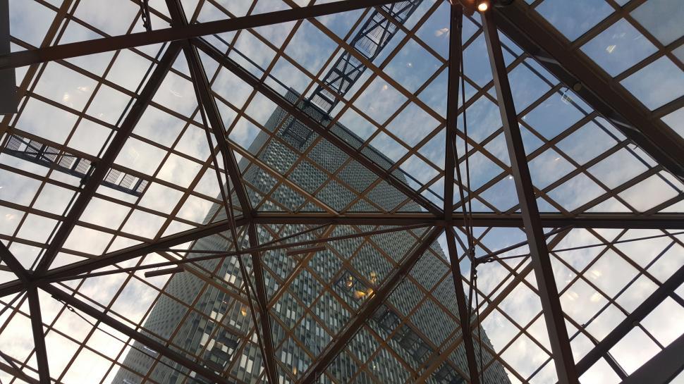 Free Image of Looking up at a Tall Building Through Metal Structure 