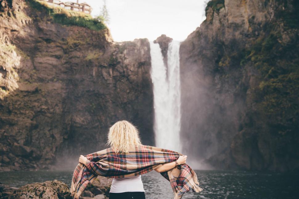 Free Image of Woman Standing in Front of Waterfall 