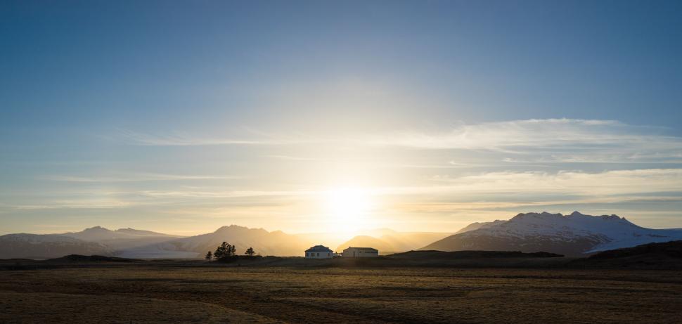 Free Image of Sun Setting Over Mountains in the Distance 