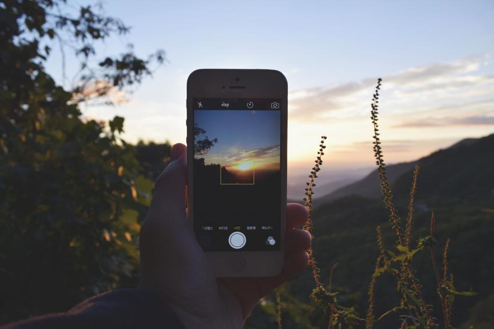 Free Image of Person Capturing Sunset With Cell Phone 