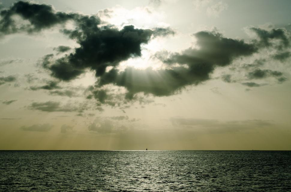 Free Image of A Large Body of Water Under a Cloudy Sky 