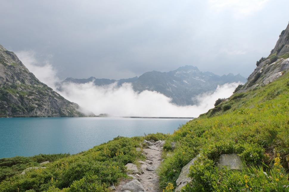 Free Image of Path Leading to Body of Water With Mountains Background 
