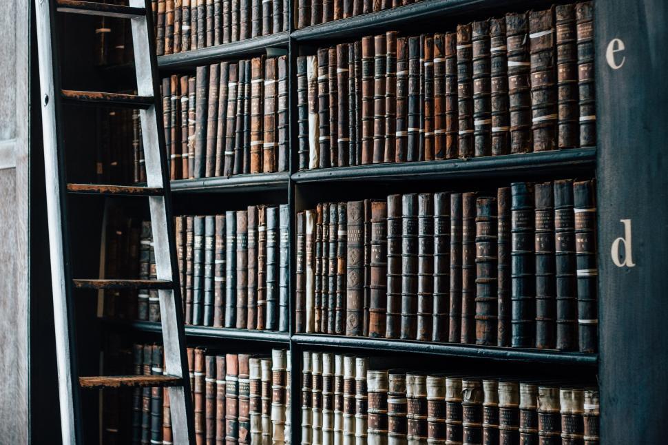 Free Image of Ladder Leaning Against Bookshelf Filled With Books 