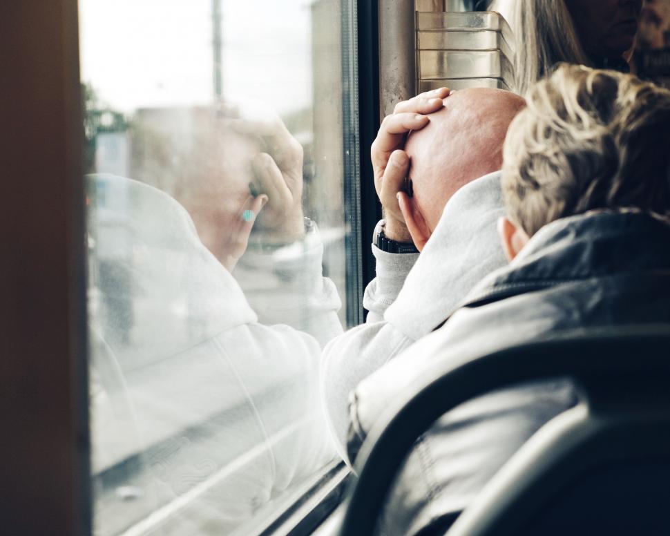 Free Image of Man Sitting on a Bus Looking Out the Window 