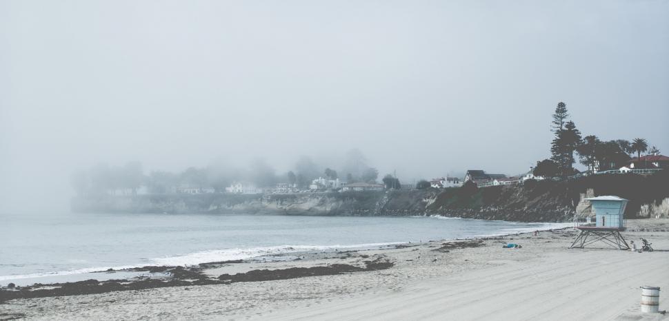 Free Image of Foggy Beach With Beach Chair and Umbrella 