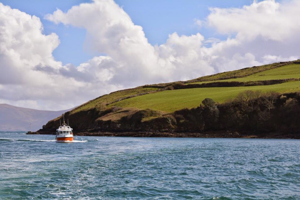 Free Image of Boat Sailing Near Hill 