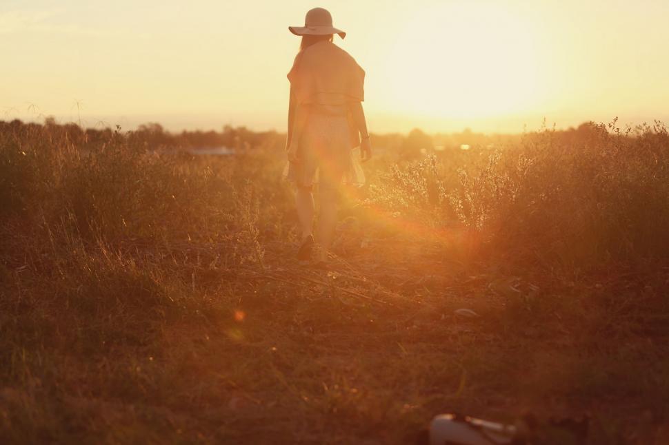 Free Image of Person Standing in Field at Sunset 