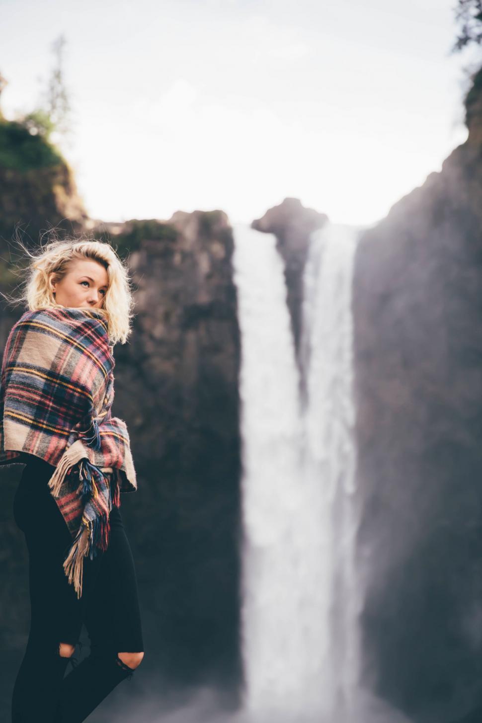 Free Image of Woman Standing in Front of a Waterfall 