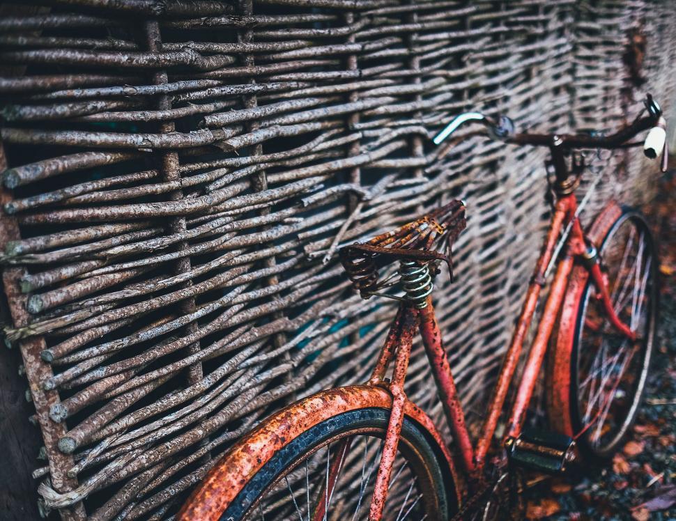 Free Image of Red Bike Parked Next to Wall 