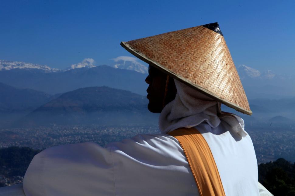 Free Image of Person Wearing Straw Hat on Mountain Top 