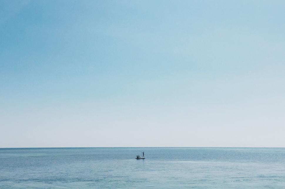 Free Image of Solitary Boat Drifting on Vast Ocean 