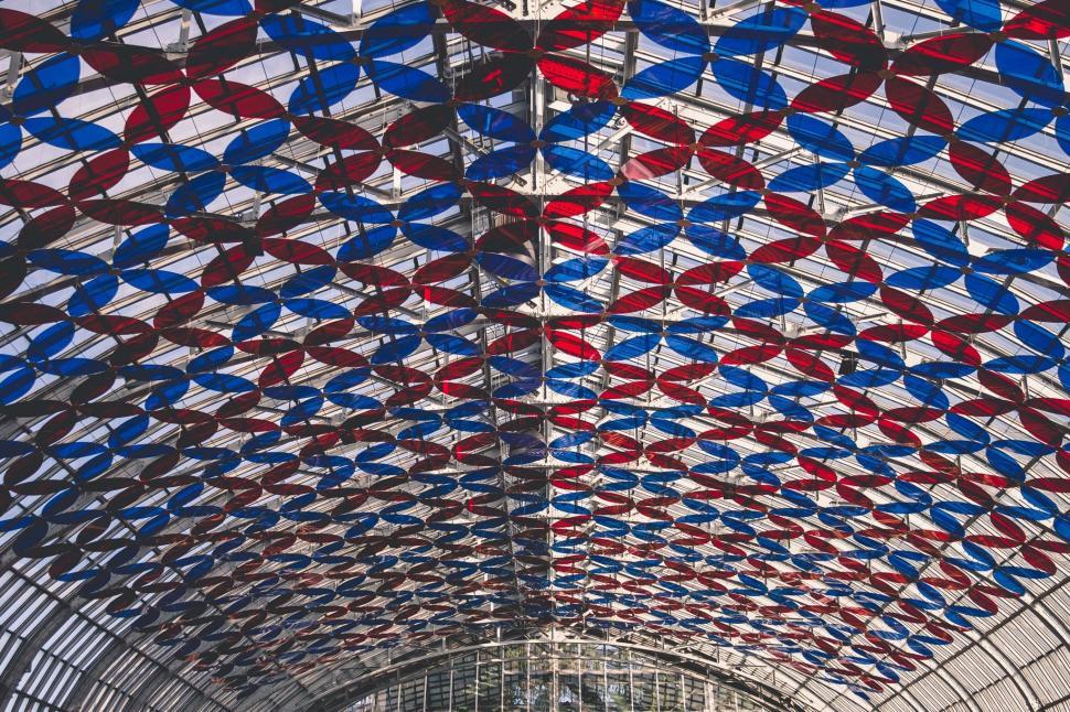 Free Image of Intriguing Red and Blue Circles Adorning Train Station Ceiling 