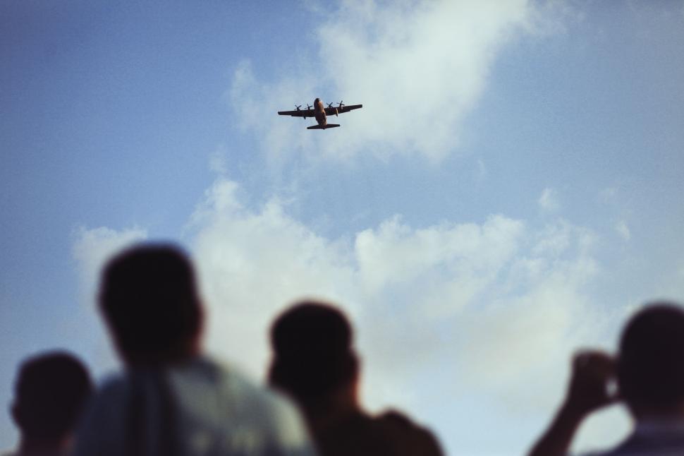 Free Image of Group of People Watching Airplane in the Sky 