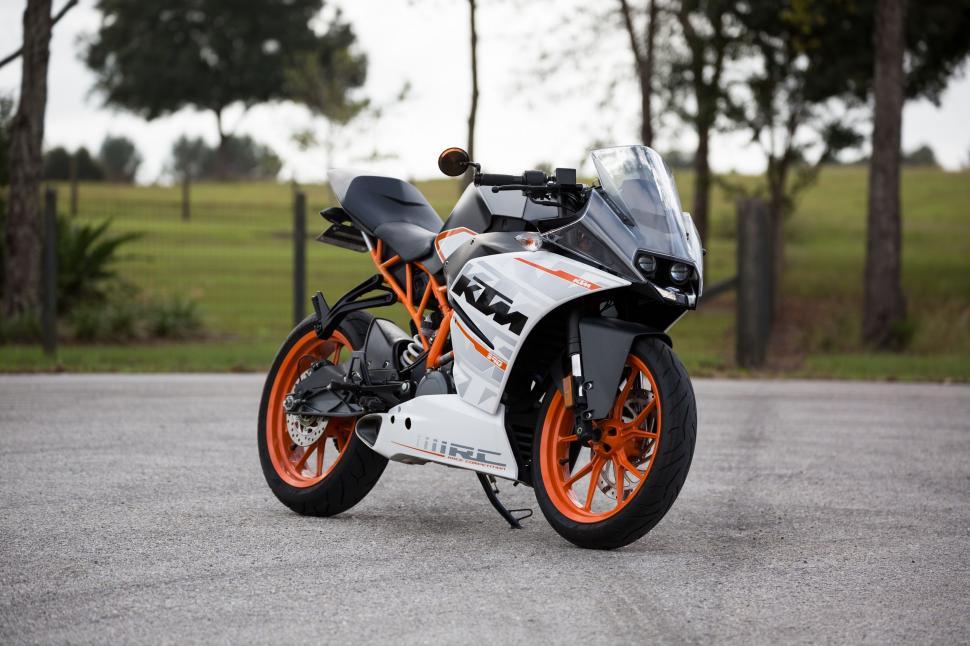 Free Image of White and Orange Motorcycle Parked in Parking Lot 