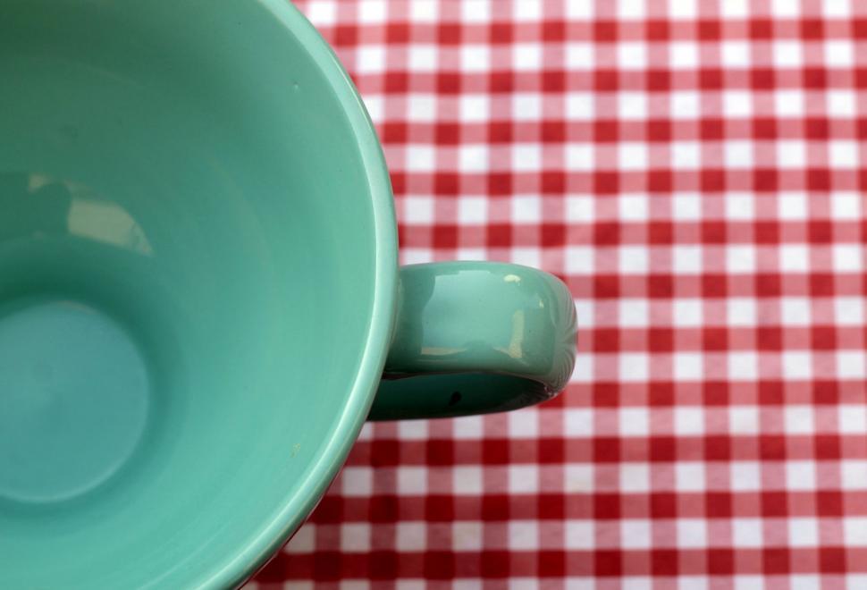 Free Image of Green Cup on Red and White Checkered Table Cloth 